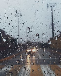 Close-up of wet glass window in rainy season