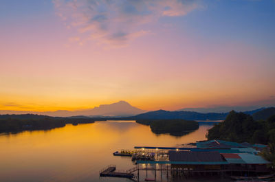 Scenic view of lake against sky during sunrise.