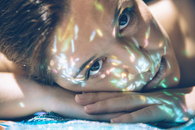 Close-up portrait of boy lying down