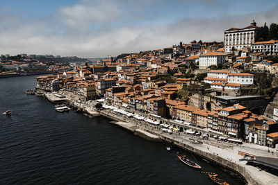 High angle view of river amidst buildings in city against sky