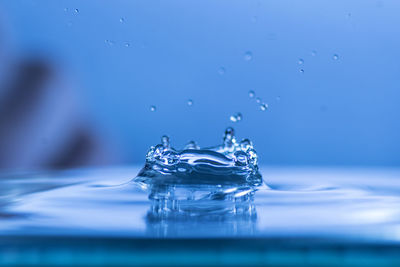 Close-up of water splashing against blue background