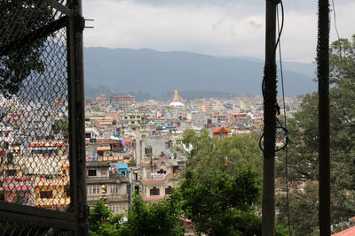 Buildings in town against sky