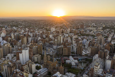 High angle view of city buildings against sky during sunset