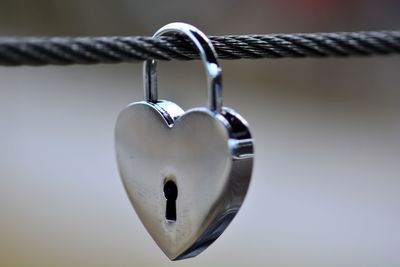 Close-up of padlocks hanging on rope