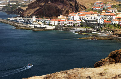 Scenic view of sea by mountains