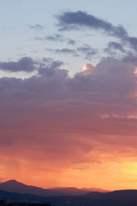 Scenic view of silhouette mountains against sky during sunset