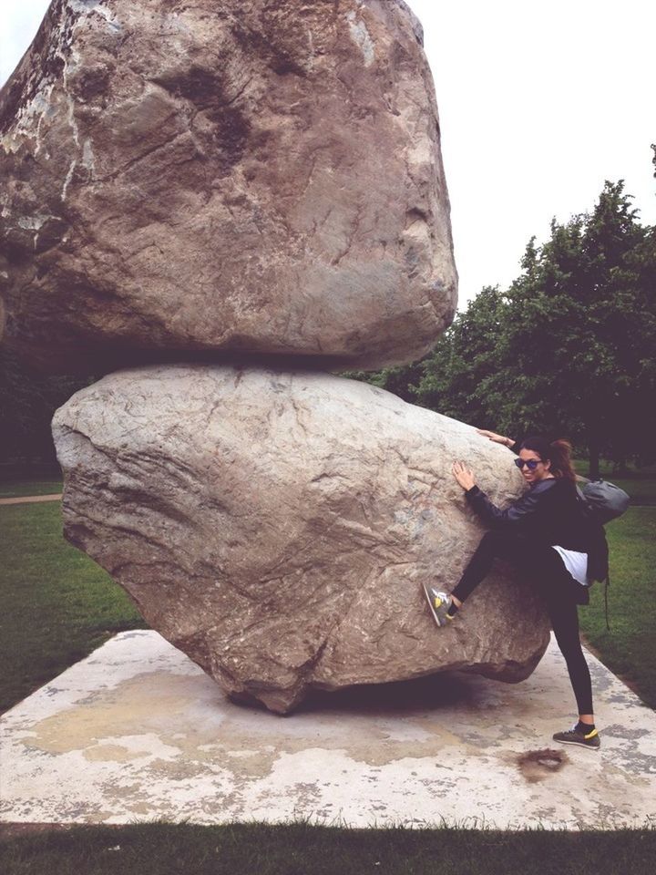 rock - object, rock formation, full length, leisure activity, lifestyles, nature, clear sky, day, sunlight, rock, tranquility, rear view, men, outdoors, tree, sky, sculpture, person