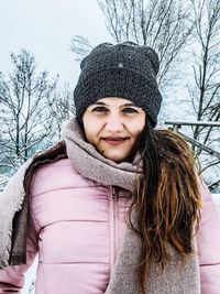 Portrait of smiling young woman in snow