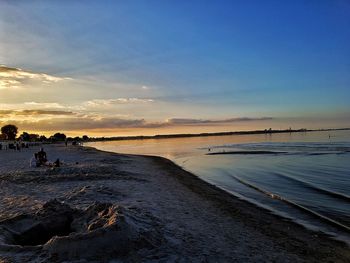 Scenic view of beach against sky during sunset