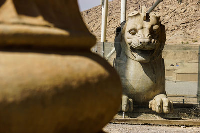 Statue against wall of building