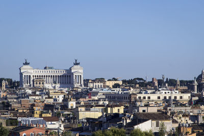 Buildings in town against blue sky