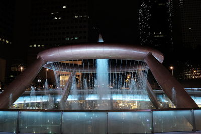 Reflection of illuminated buildings in city at night