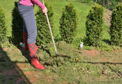 Low section of person standing on grassland