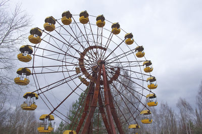 Low angle view of ferris wheel against sky