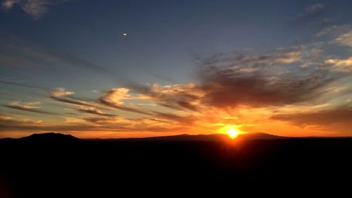 Scenic view of silhouette landscape against sky during sunset