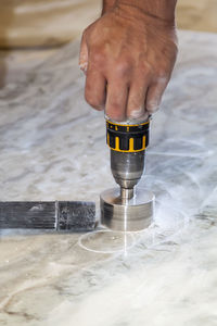 Close-up of man working on floor