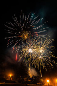 Low angle view of firework display at night