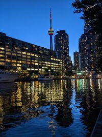 Illuminated buildings in city at waterfront