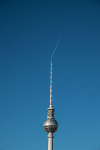 Low angle view of fernsehturm tower against clear blue sky