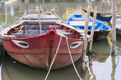 Red wood fishing boat moored in hoi an canal, vietnam