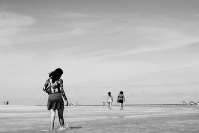 Rear view of women at beach