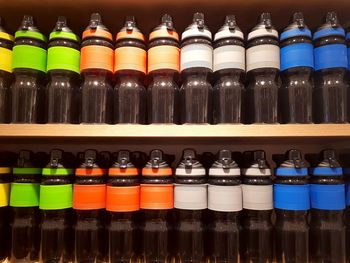 Multi colored bottles on shelf