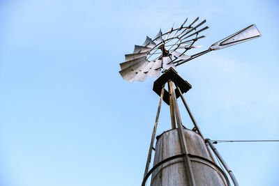 Low angle view of traditional windmill against sky