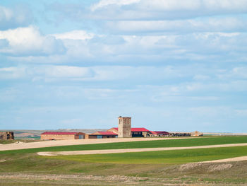 Built structure on landscape against sky