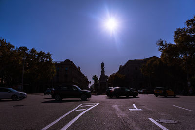 Cars on road in city against sky