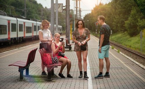 Friends standing on railroad station platform