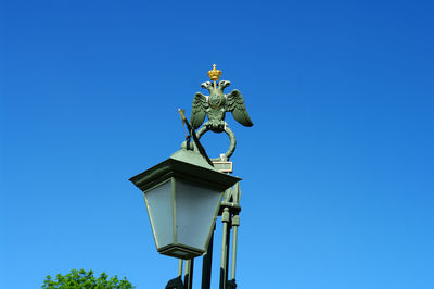 Low angle view of sculpture against clear blue sky