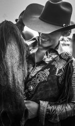 Close-up of smiling young woman with horse