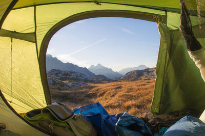 Mountains against sky seen through tent