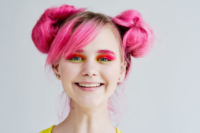 Close-up of young woman against white background