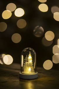 Close-up of illuminated light bulbs on table