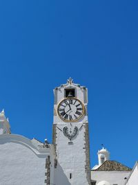 Low angle view of clock tower against sky