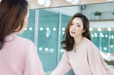 Portrait of beautiful woman standing at home