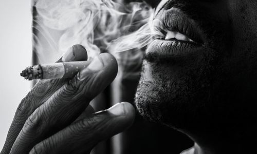 Close-up of man smoking cigarette