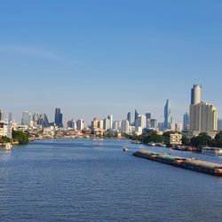 City by buildings against clear sky