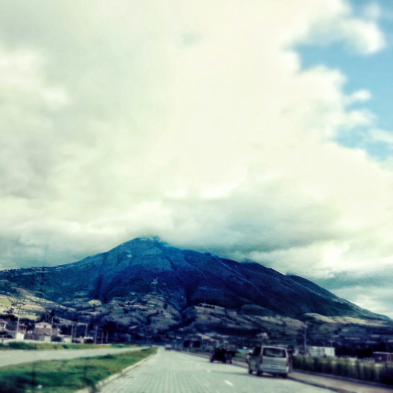 transportation, sky, road, mountain, car, cloud - sky, land vehicle, the way forward, cloudy, cloud, mode of transport, street, landscape, mountain range, country road, diminishing perspective, nature, vanishing point, scenics, outdoors