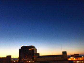 View of illuminated cityscape against clear sky