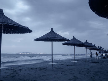 Built structure on beach against sky