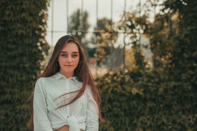 Portrait of smiling woman standing outdoors