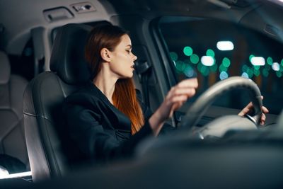 Young woman driving car