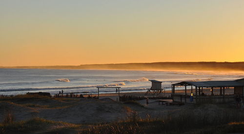 Scenic view of sea against clear sky during sunset