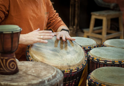 Midsection of man playing guitar