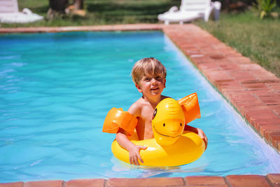 Portrait of boy playing in swimming pool