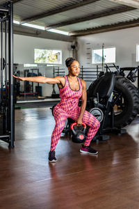 Full length of woman exercising in gym