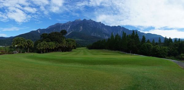Scenic view of landscape and mountains against sky