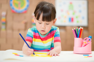 Young girl practice drawing different shapes for homeschooling